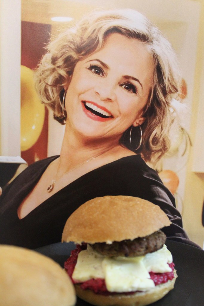 Amy Sedaris preparing to devour a delightful Lamby Slidaris